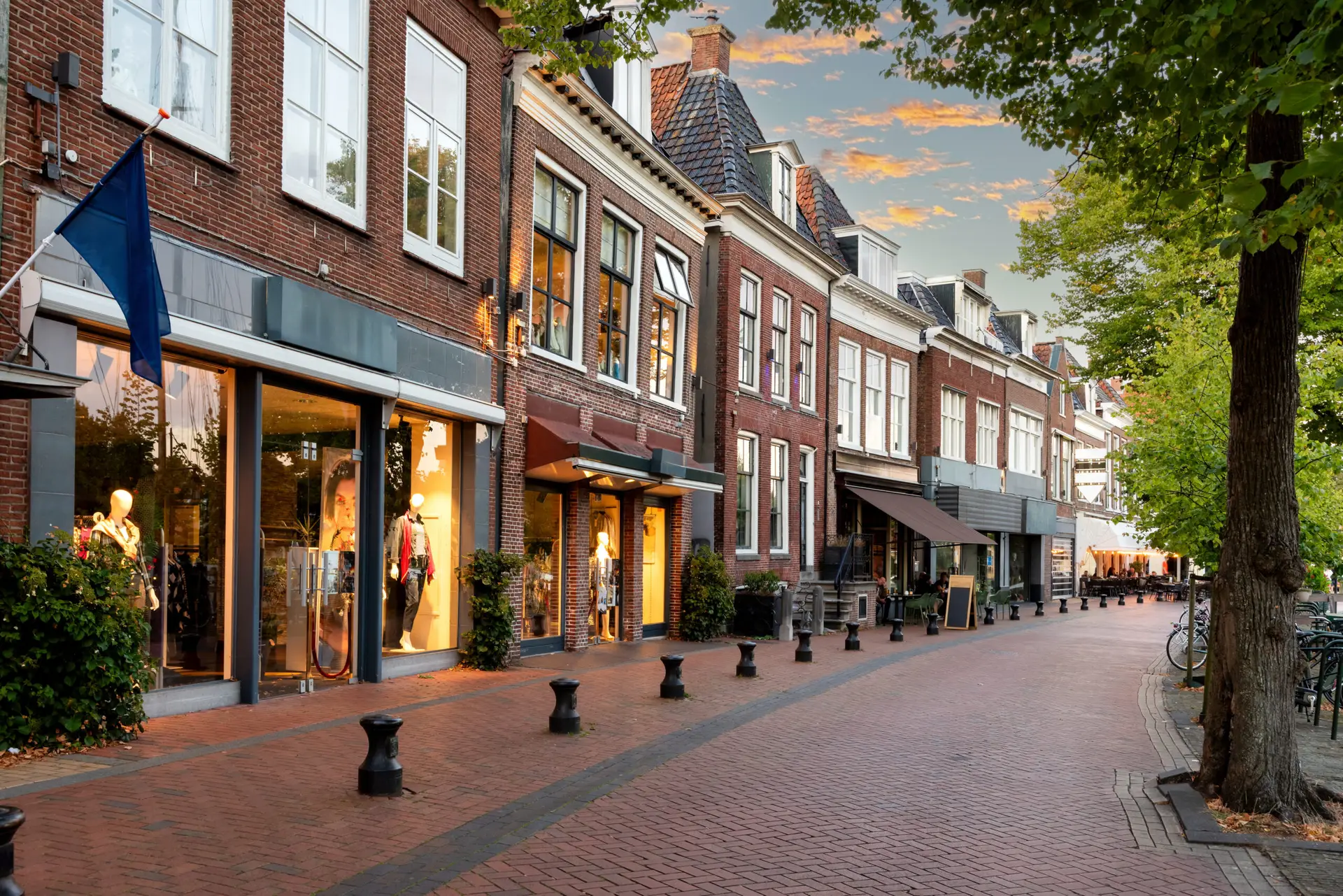 Small shopping street with restaurants in Diepswal street at evening, Dokkum, Netherlands
