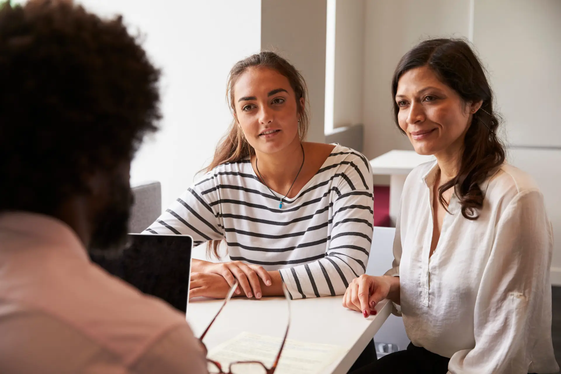 Mother And Daughter Meeting With Male Teacher
