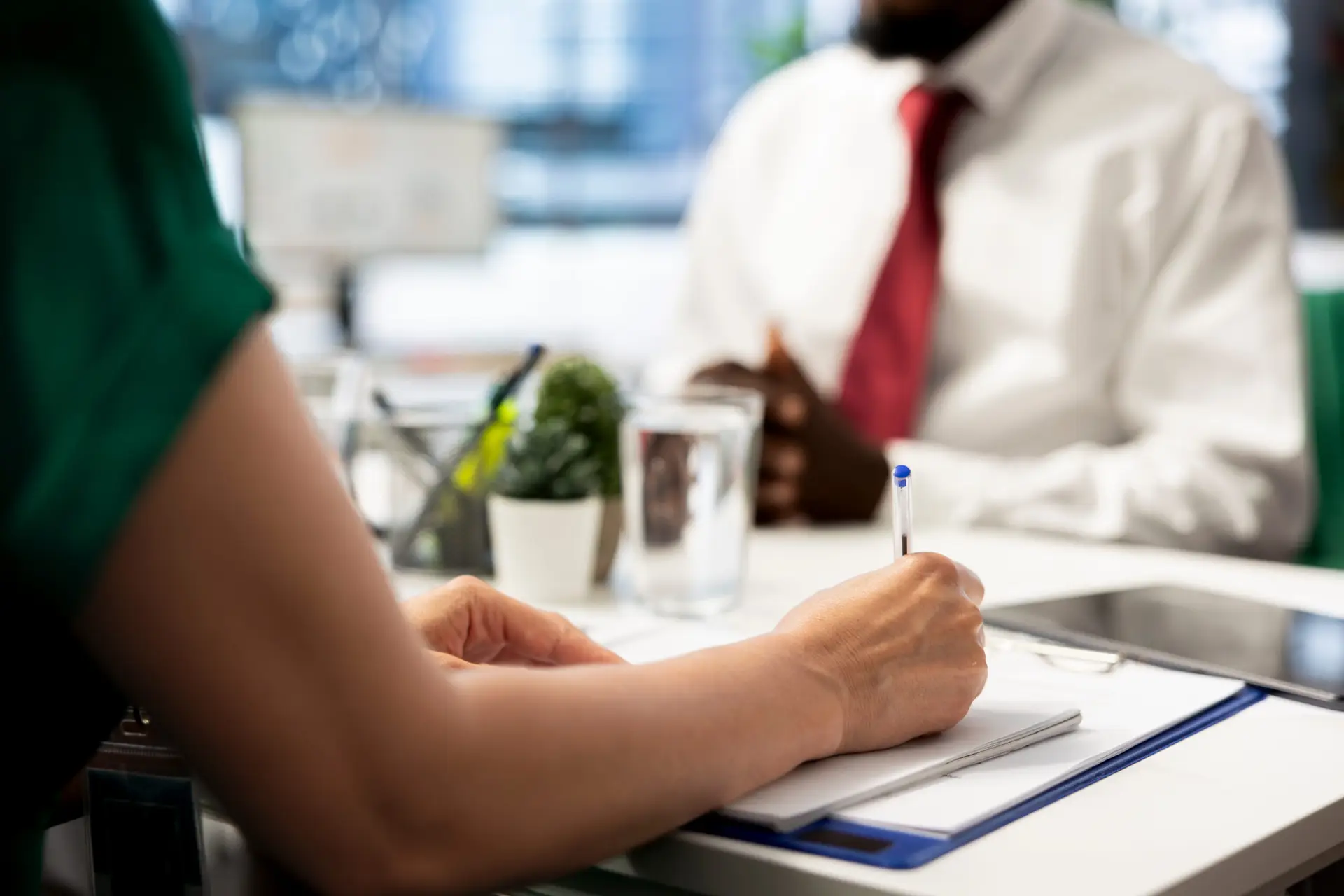 HR employee filling in paperwork after making sure candidate possesses skills