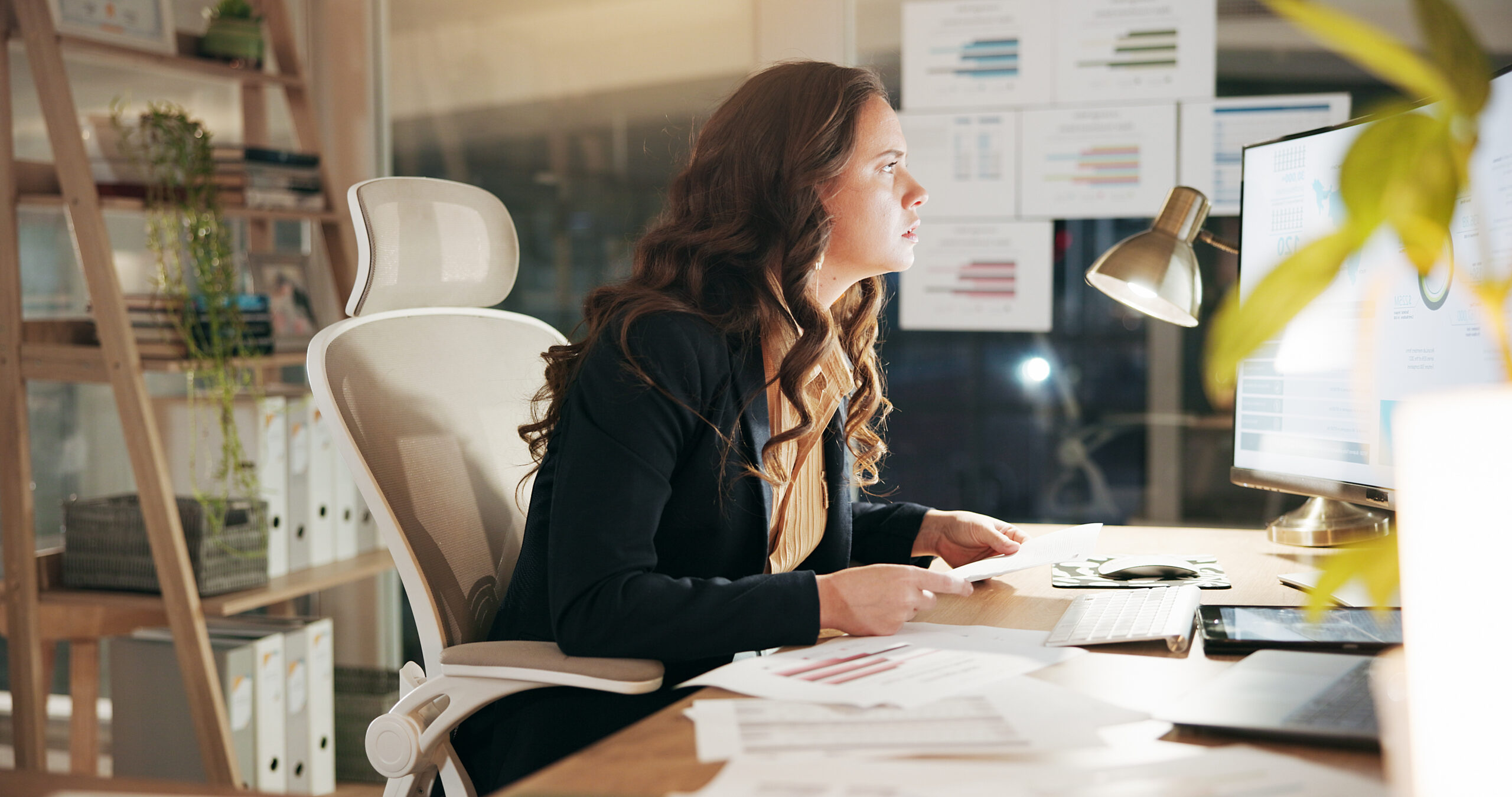 Business, night and woman with computer, stress and financial agency with inflation. Evening, person and investor in workplace, pc and stock market exchange with mistake, fail and bankruptcy