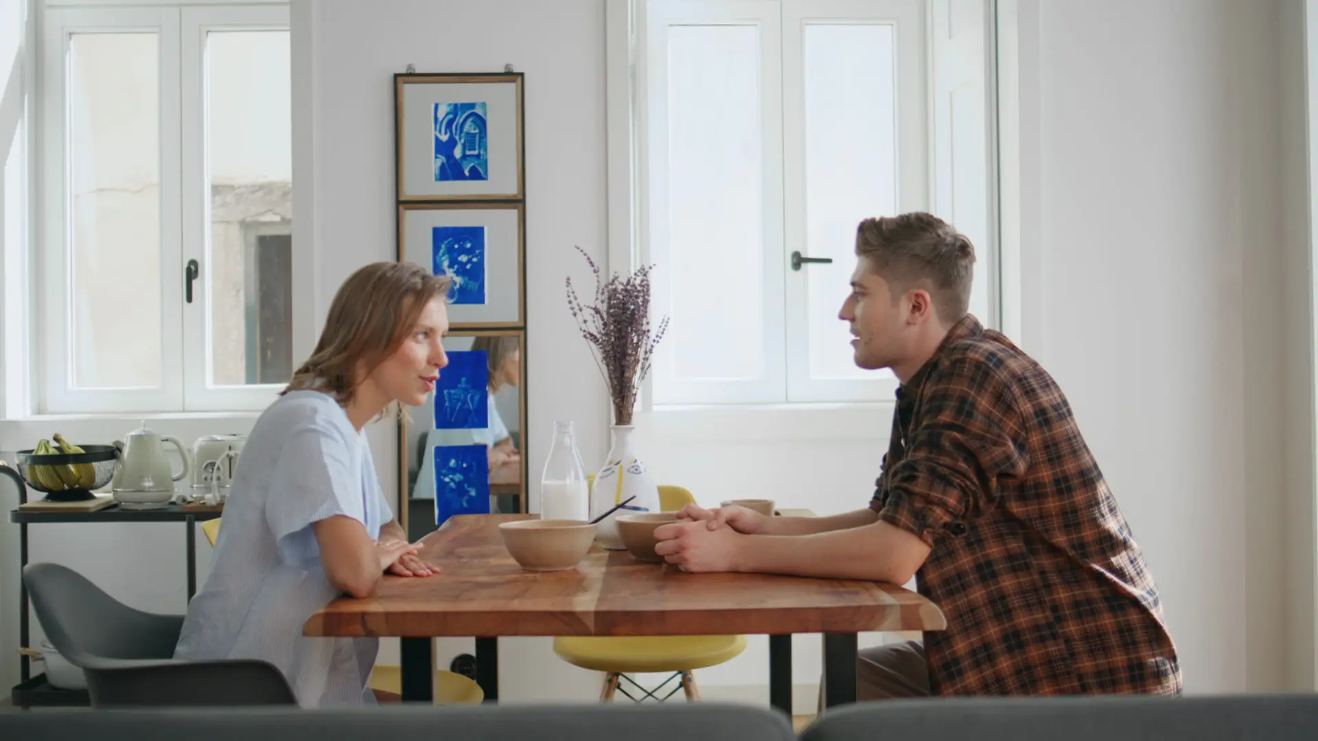 Relaxed partners communicating kitchen in calm morning. Smiling couple breakfast