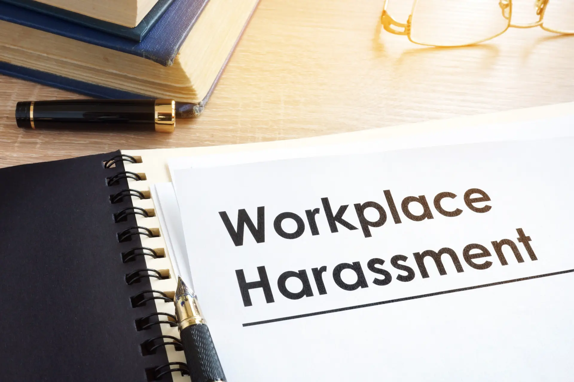 Documents about workplace harassment in an office.