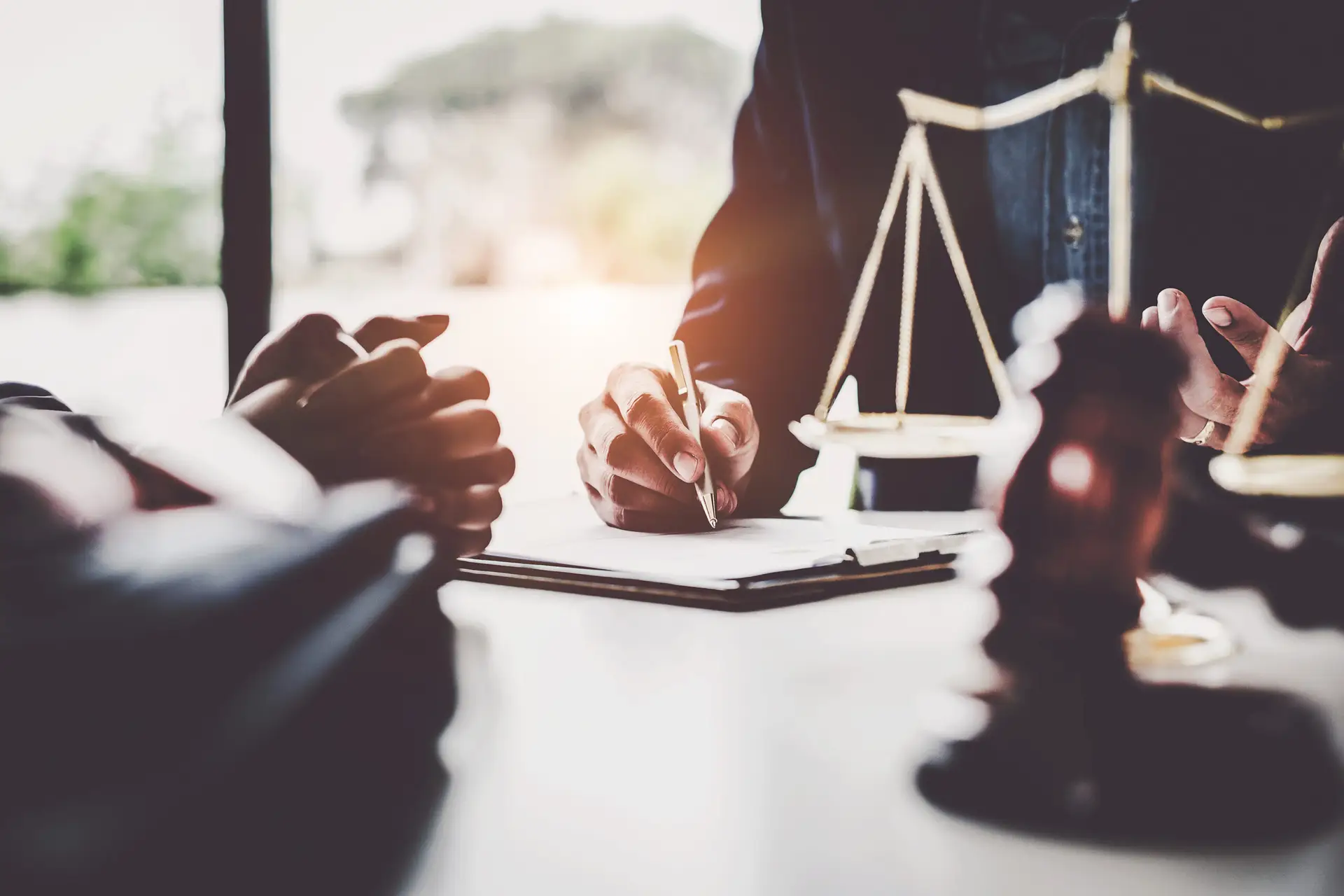 Business woman and lawyers discussing contract papers with brass