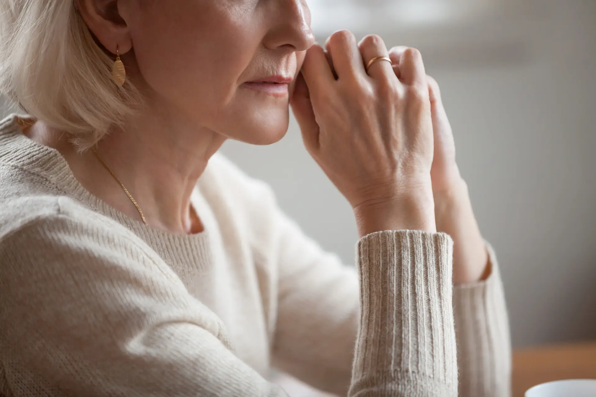 Close up view of thoughtful mature woman worried about problems