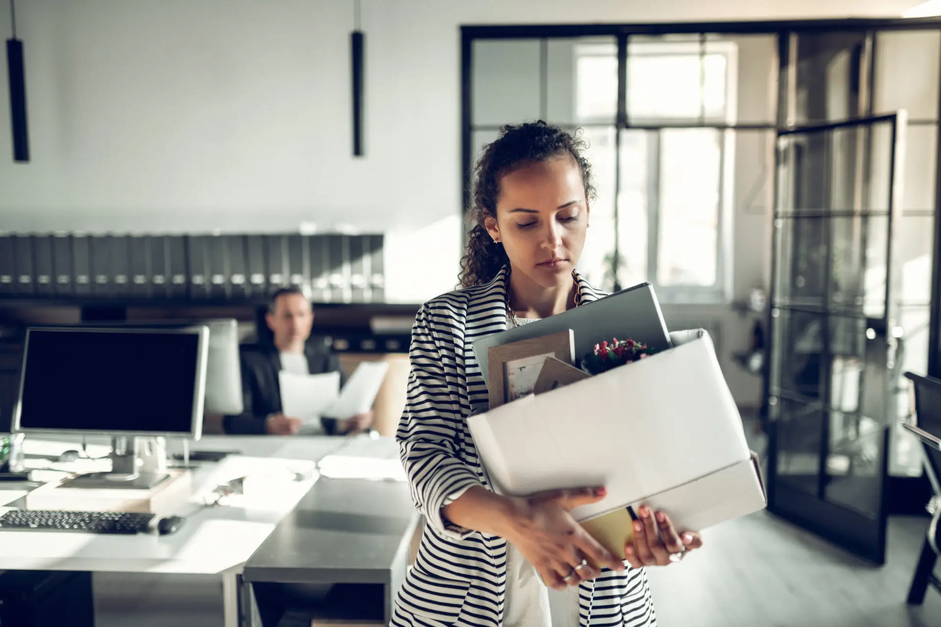 Curly trainee feeling sad after being fired by her boss