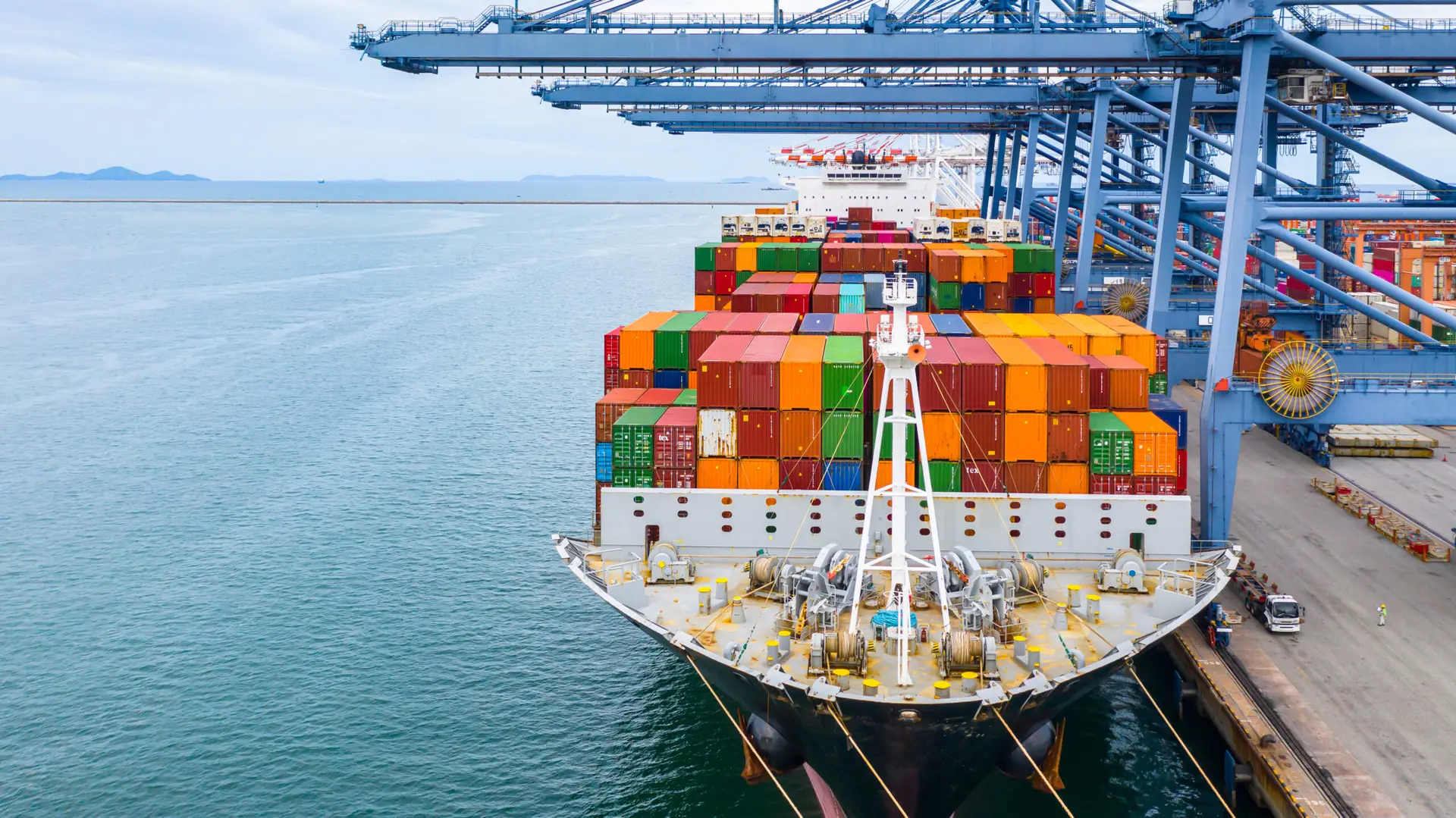Container cargo freight ship terminal, Unloading crane of cargo ship terminal business, Industrial port with commercial container box and container ship boat in China.