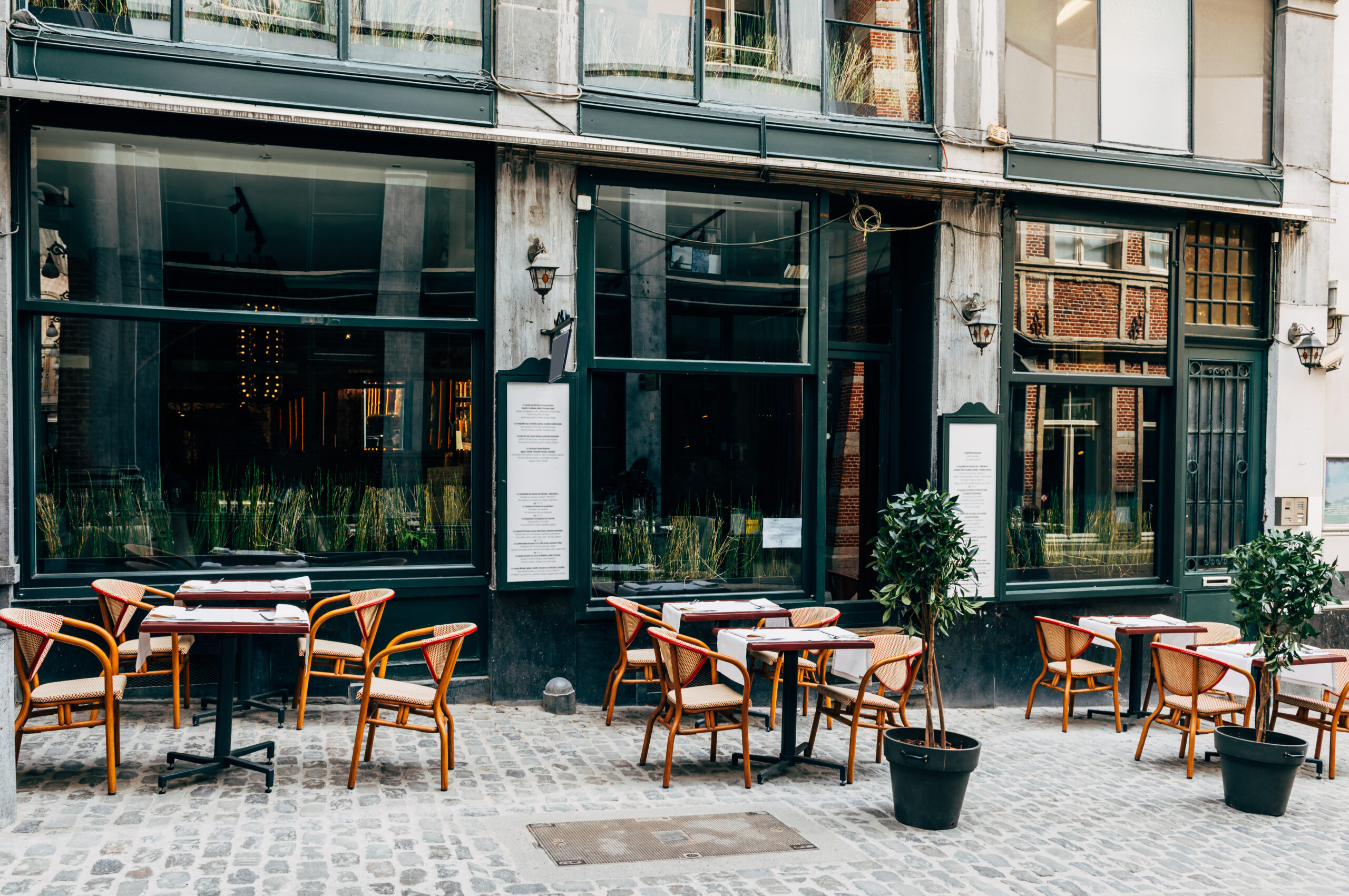 Old street with tables of cafe in center of Brussels, Belgium. C