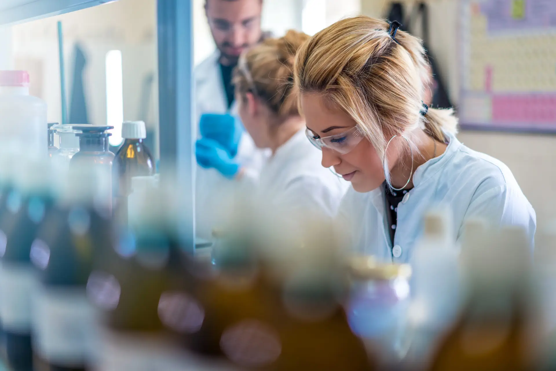 Beautiful young woman scientist in laboratory working. Young fem