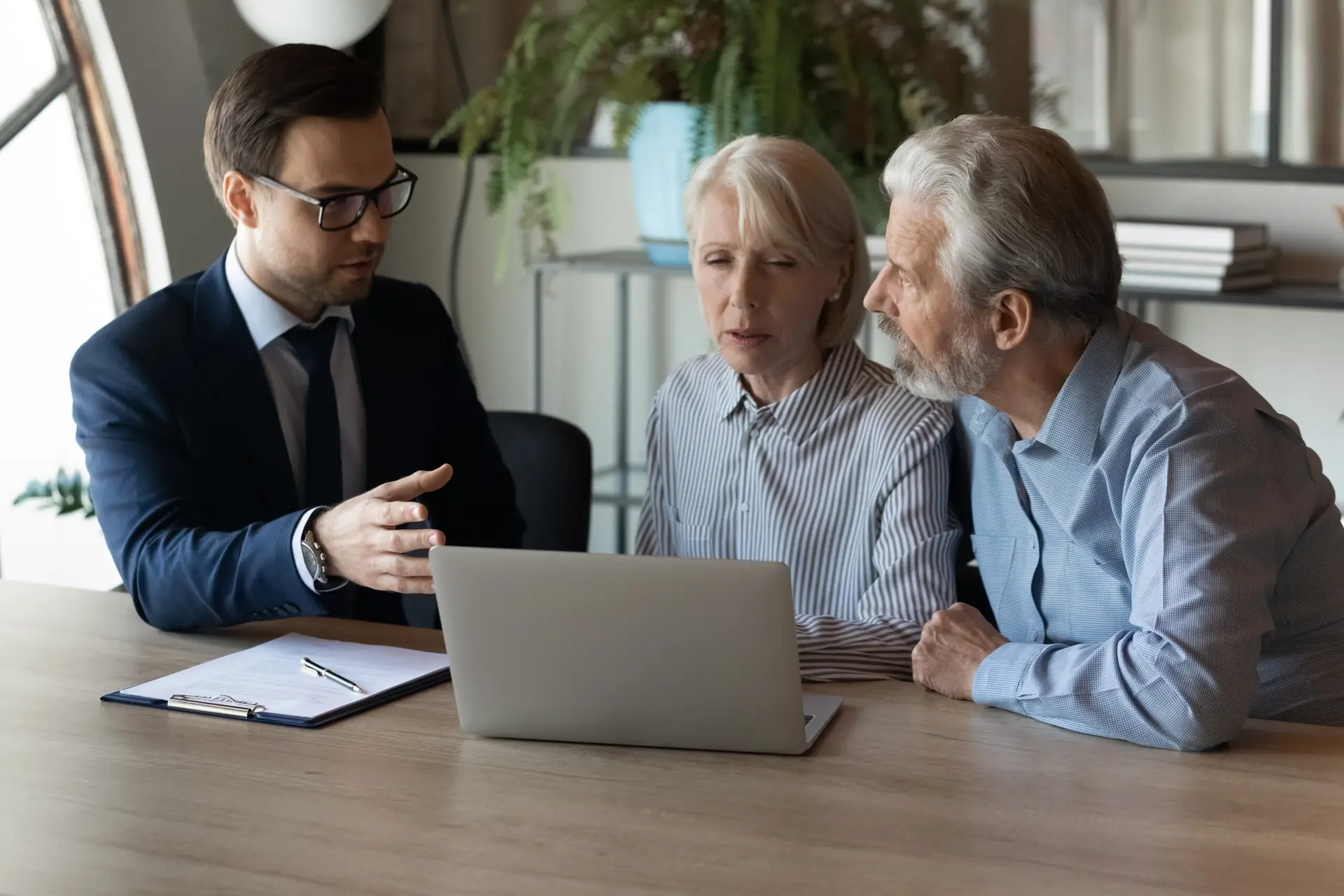 Older clients consulting agent, broker about house selling
