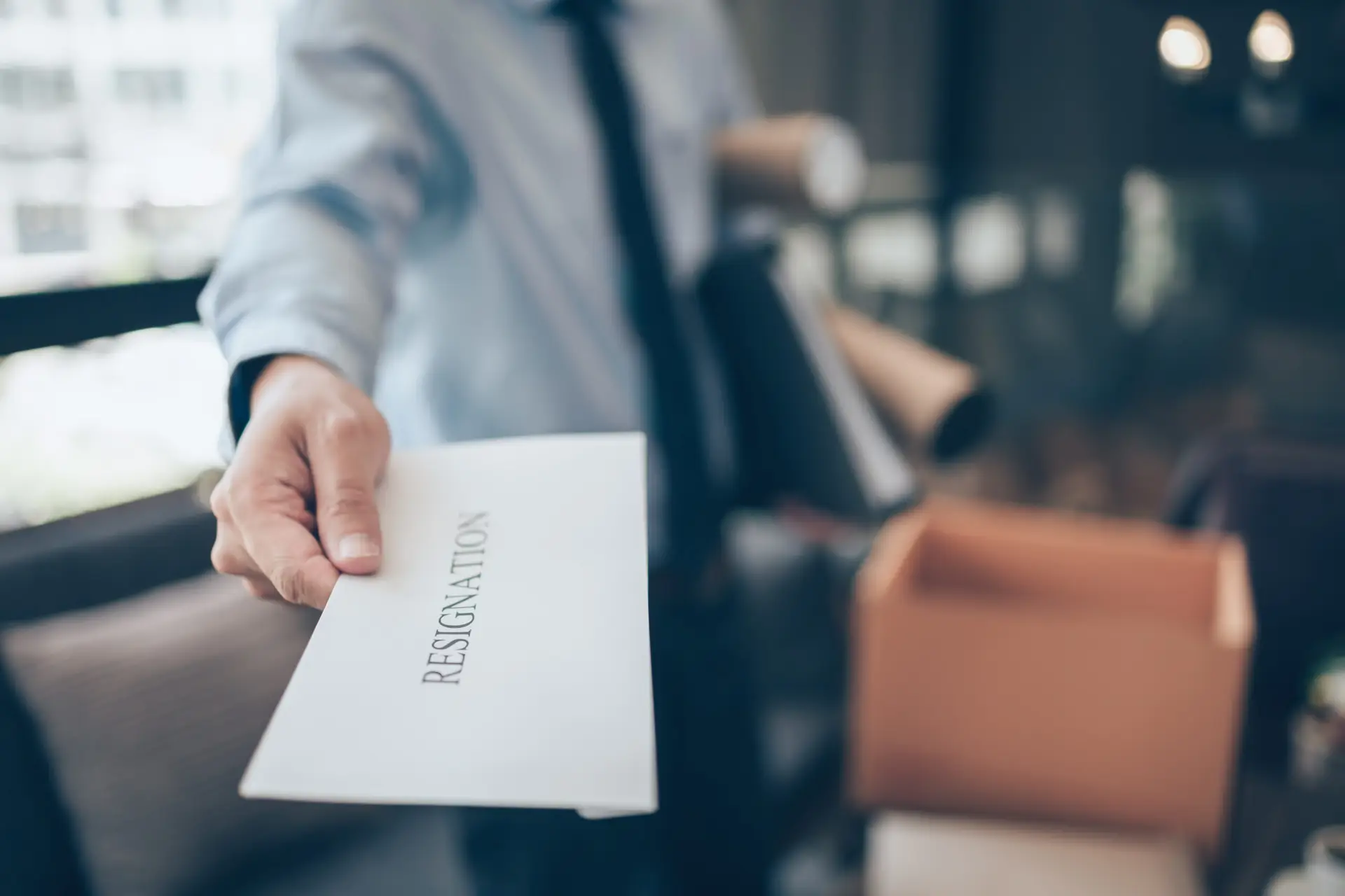 Businessman sending and showing resignation letter to employer boss. Quiting a job, businessman fired or leave a job concpet.