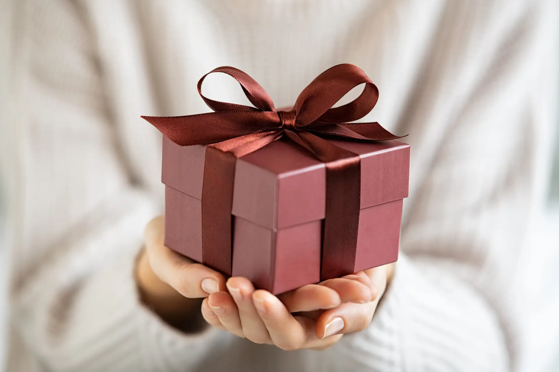 Woman holding beautiful and elegant gift box