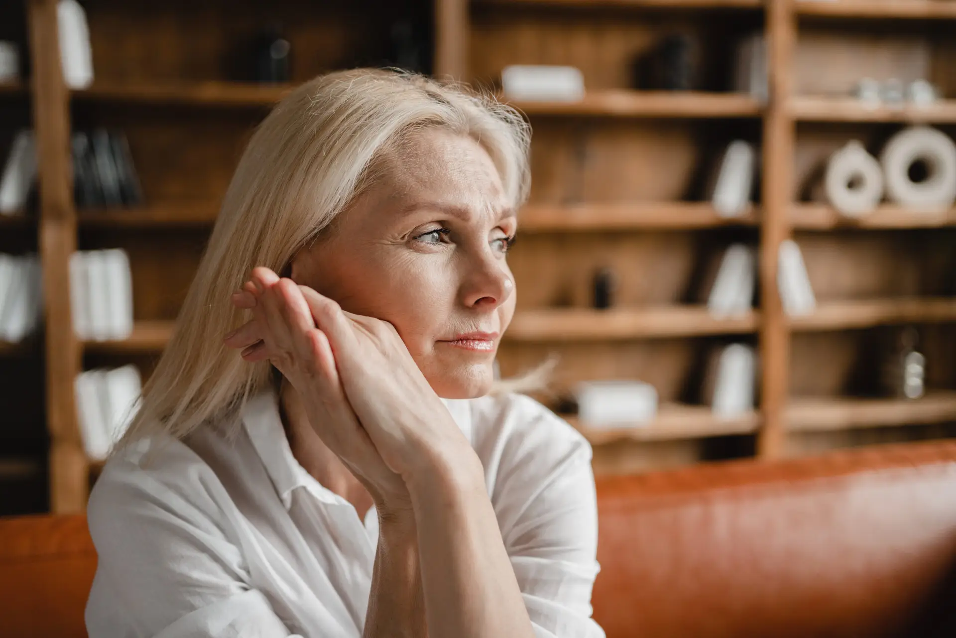 Psychologist appointment. Stressed sad tired exhausted caucasian middle-aged mature businesswoman freelancer relaxing on the couch sofa, thinking about family marriage work problems at work office