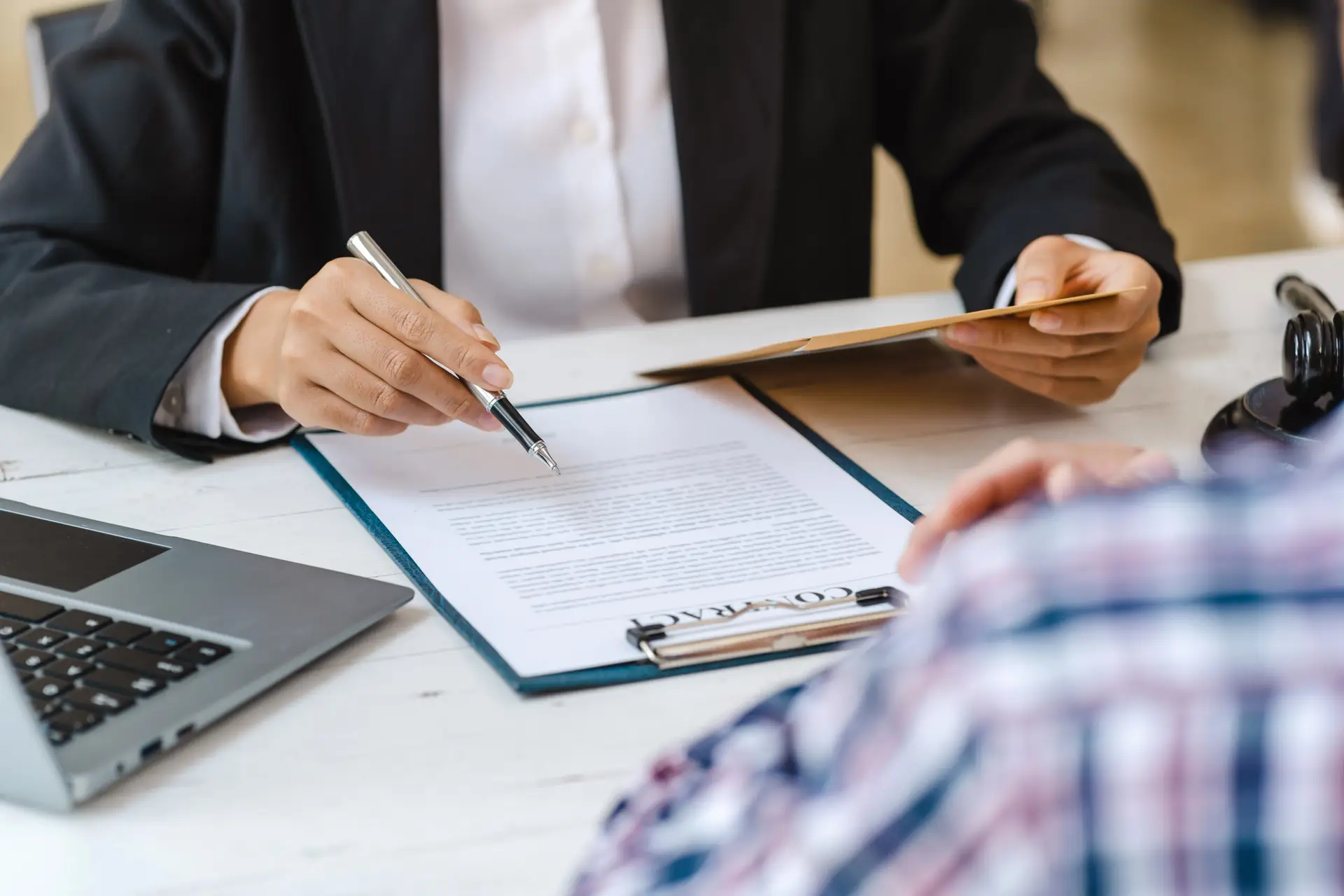 Business people negotiating a contract. Human hands working with documents at desk and signing contract.