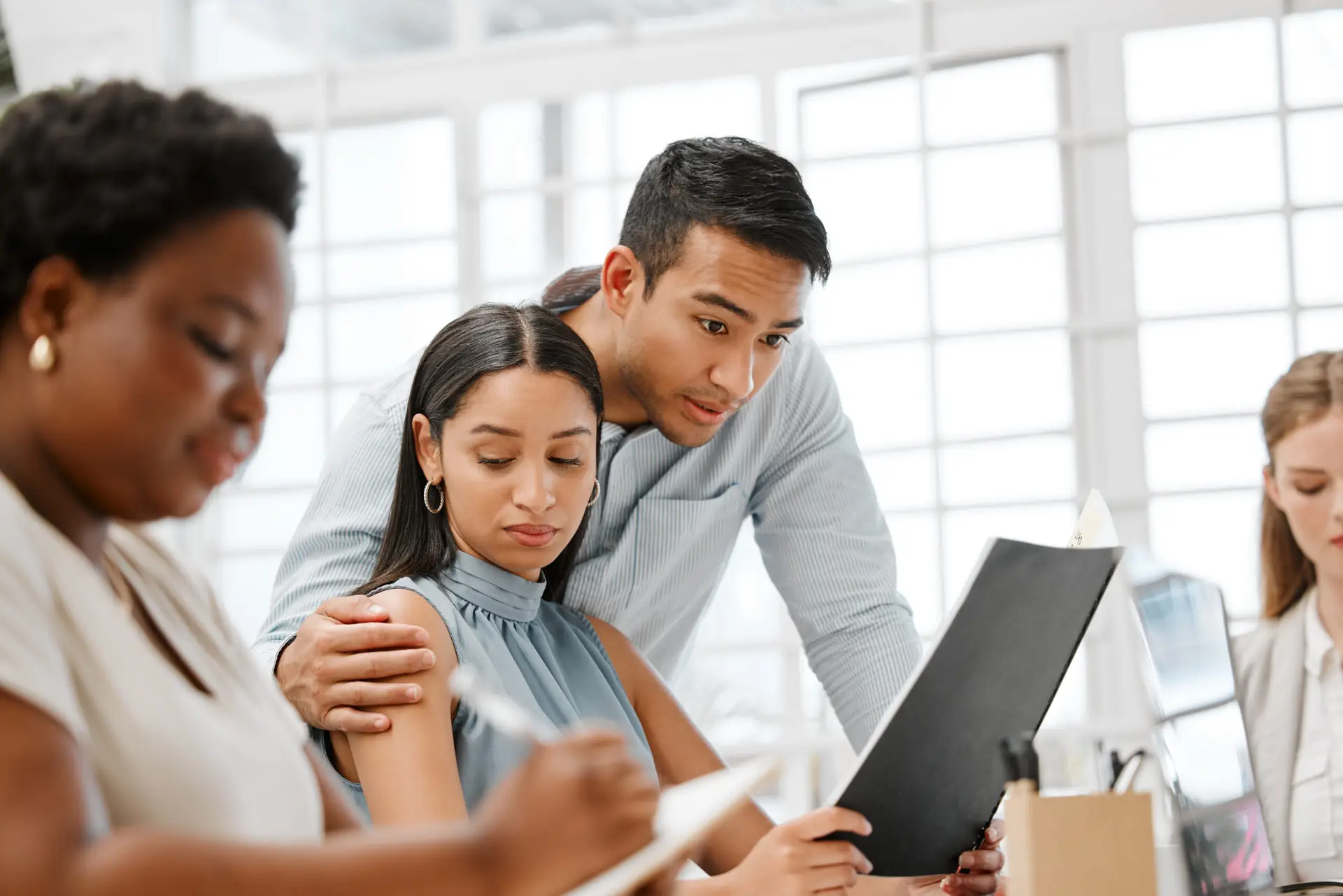 Sexual harassment or inappropriate touch by a businessman on a female employee by putting his hand on her. Unhappy and awkward female coworker feeling uncomfortable due to behavior in the office
