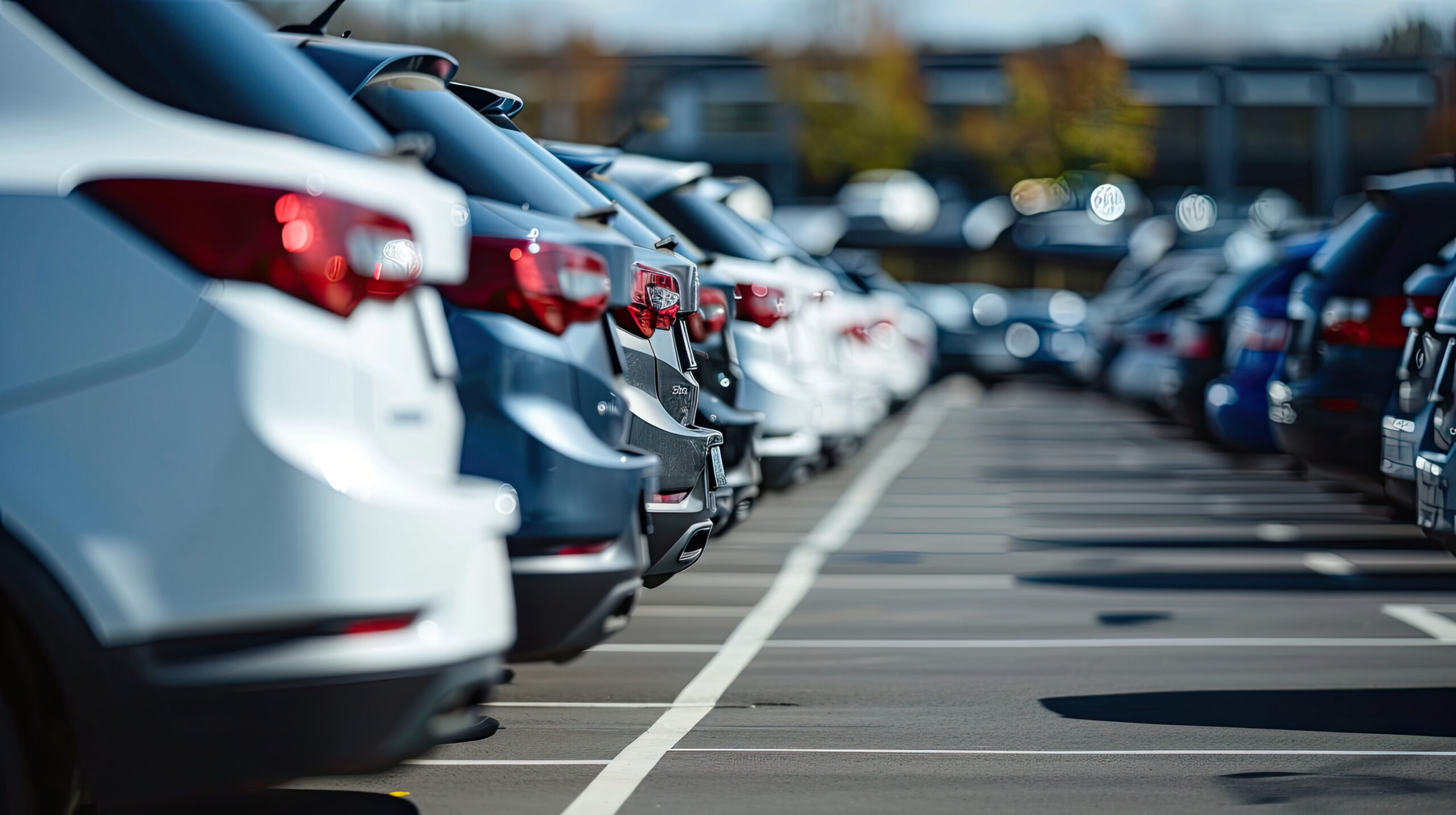 Car parked at outdoor parking lot. Used car for sale and rental service. Car insurance background. Automobile parking area. Car dealership and dealer agent concept. Automotive industry