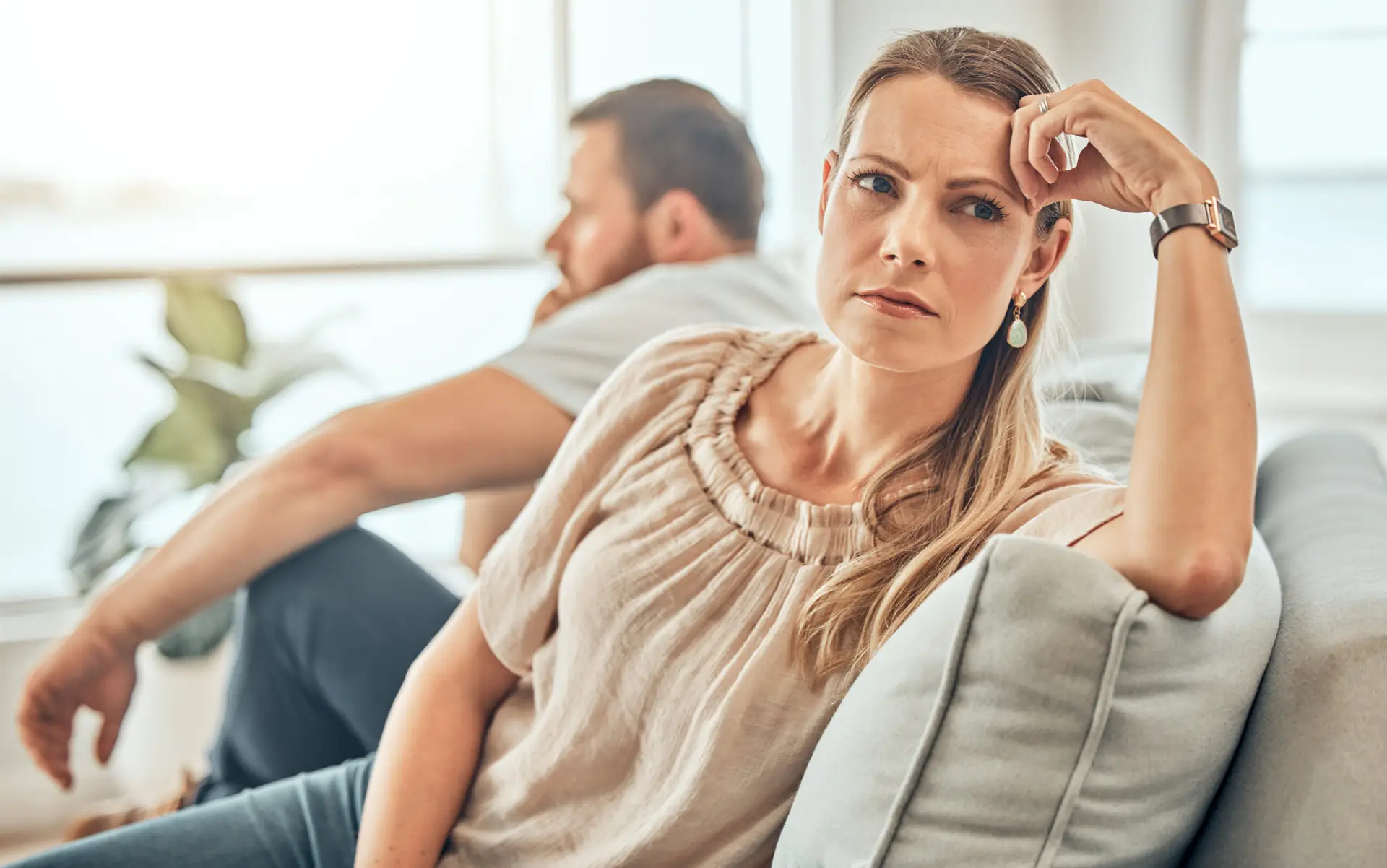Couple, fighting and woman ignoring on sofa, marriage counselling and office for conflict resolution. Infidelity, cheating spouse and drama on couch, relationship crisis and disagreement for betrayal