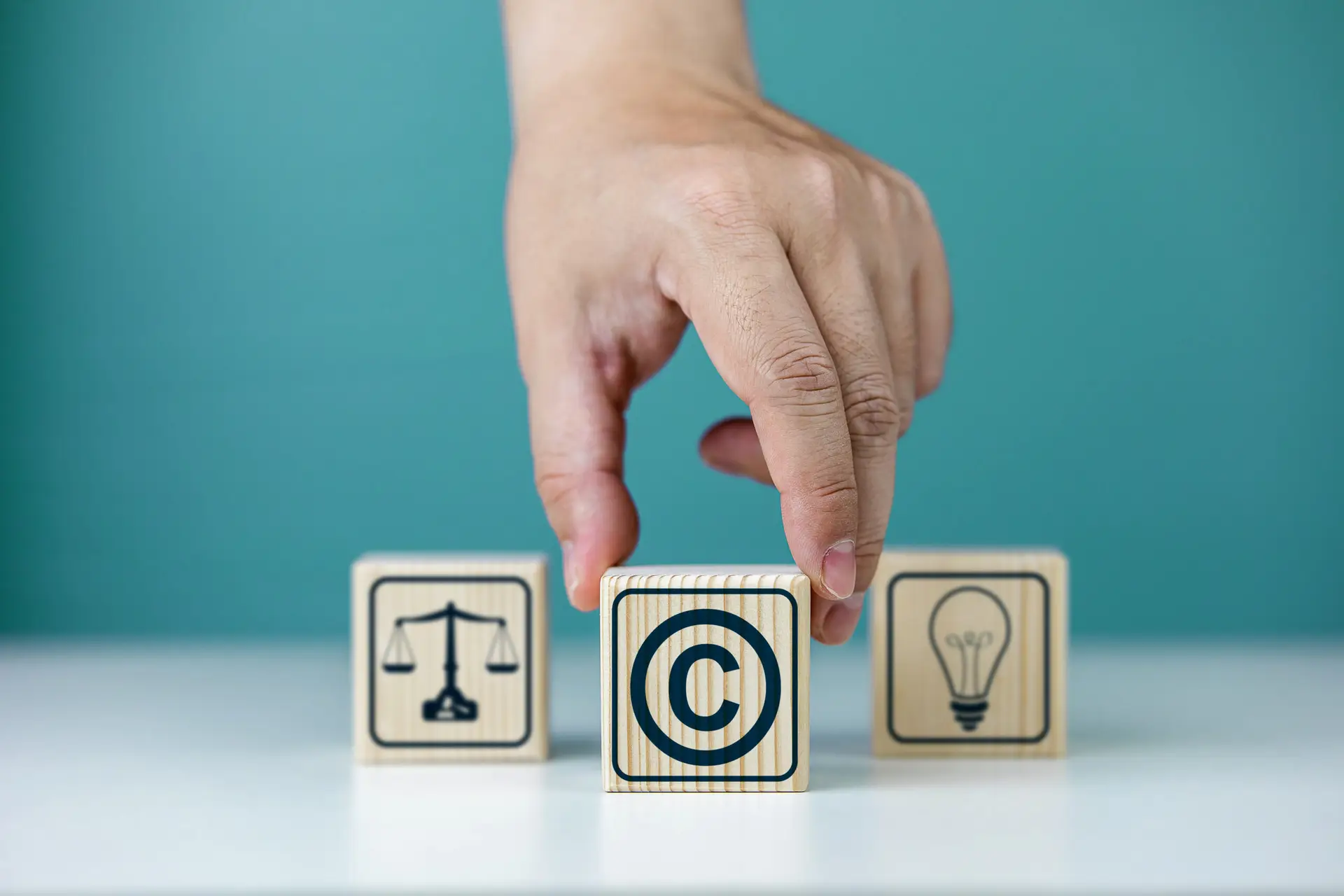 Copyright symbol or intellectual property rights of patentee on wooden cube. Business concept of author rights, designer, and trademark license
