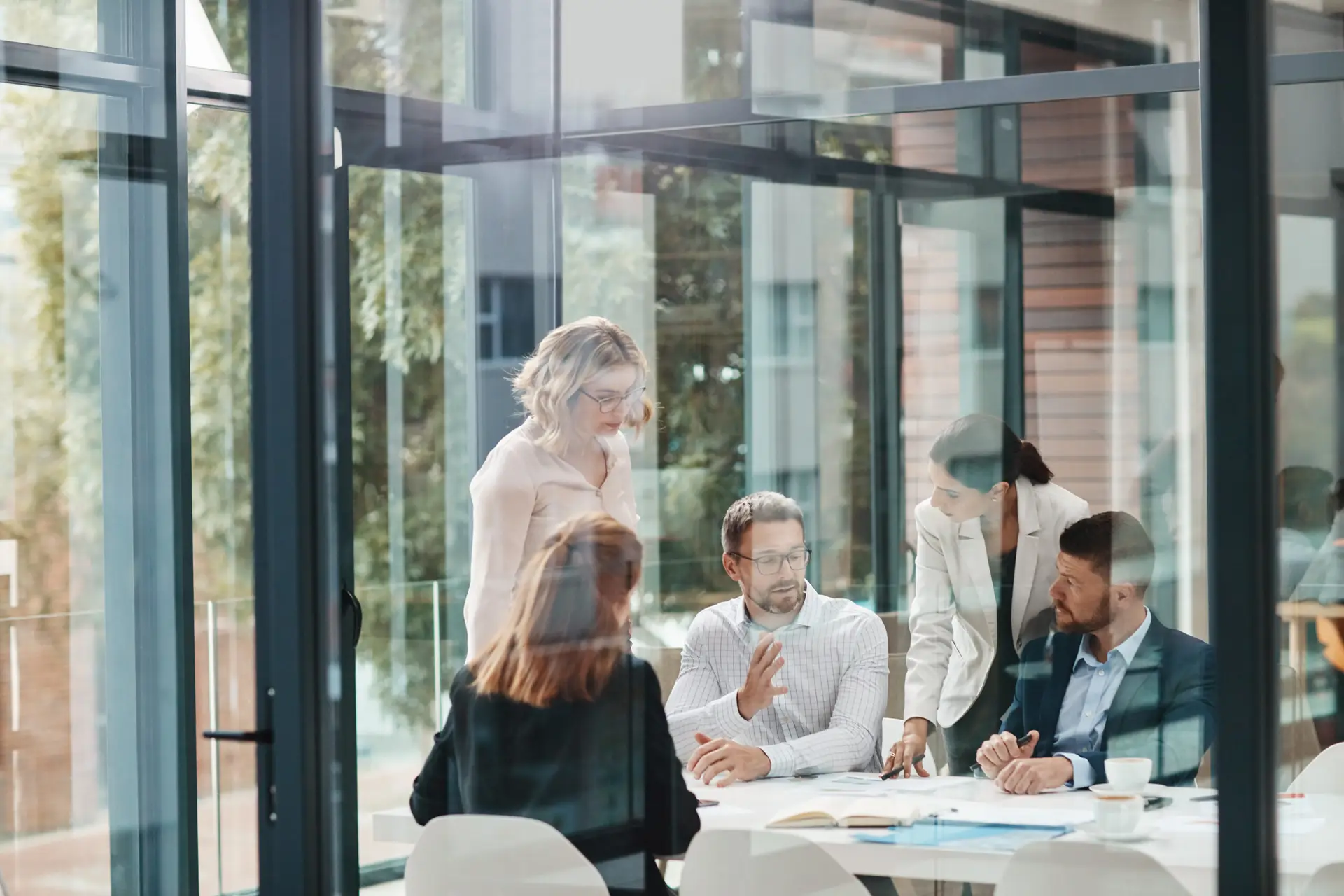 Window, business people or planning in meeting for paperwork, teamwork or collaboration together. Shareholders, investor or executive director speaking in discussion for feedback, review or project