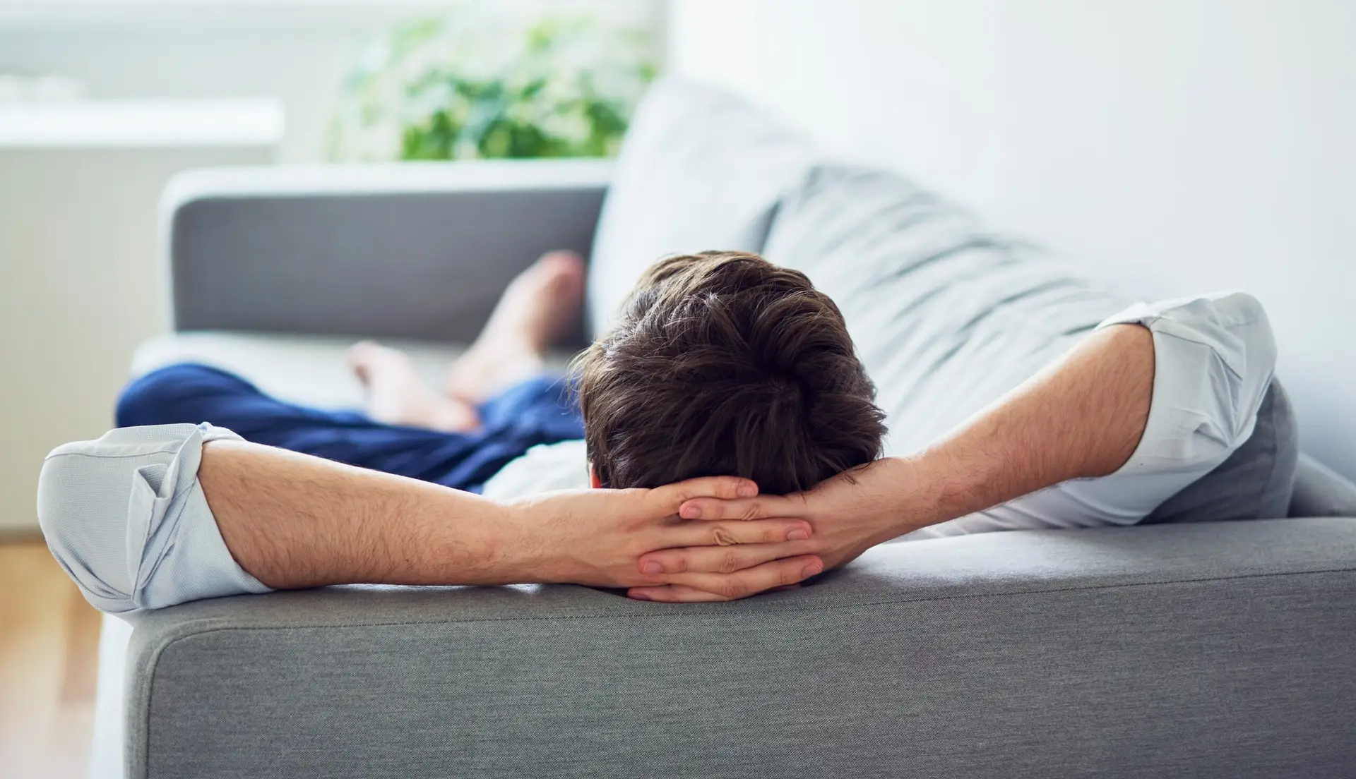 Young man relaxing on sofa after work