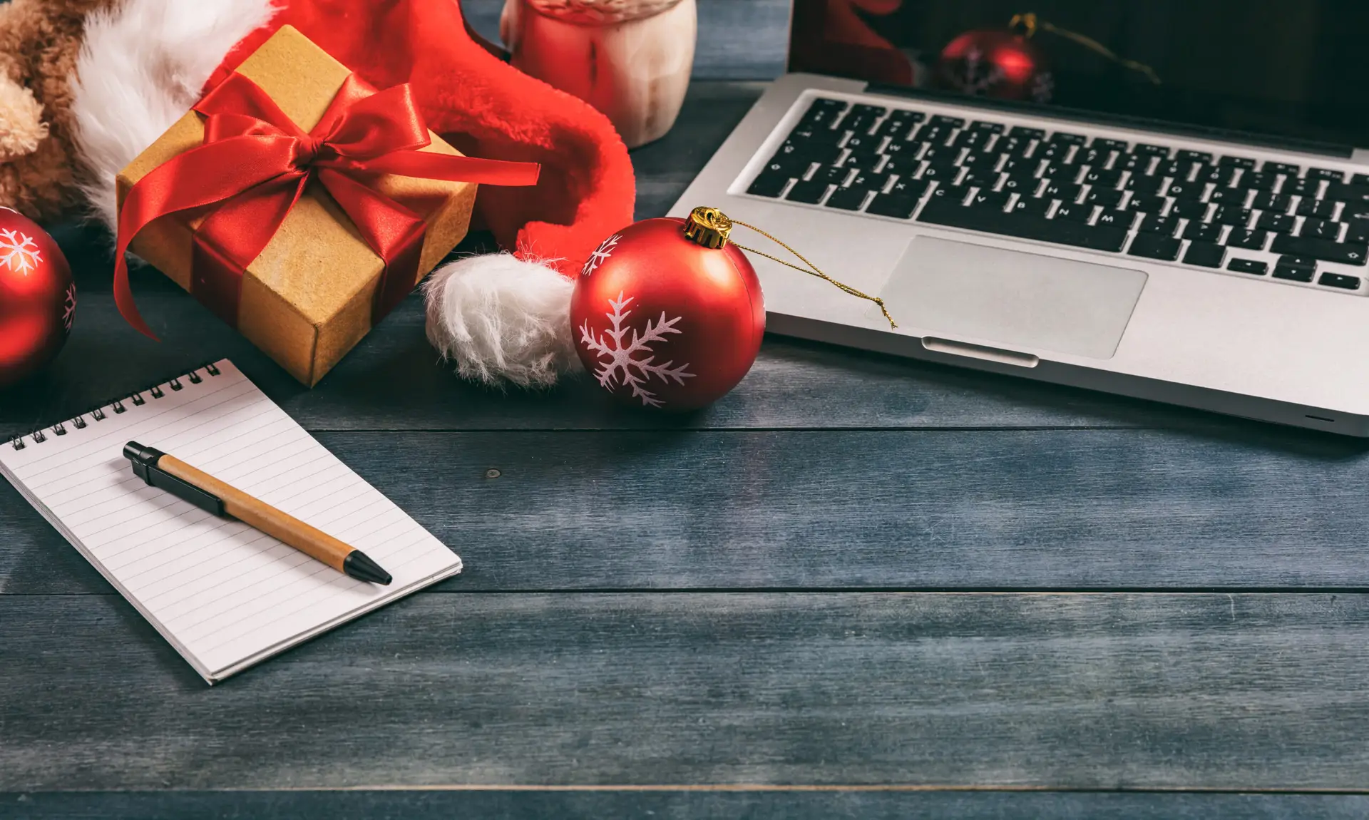 Christmas decoration and a laptop on an office desk, copy space