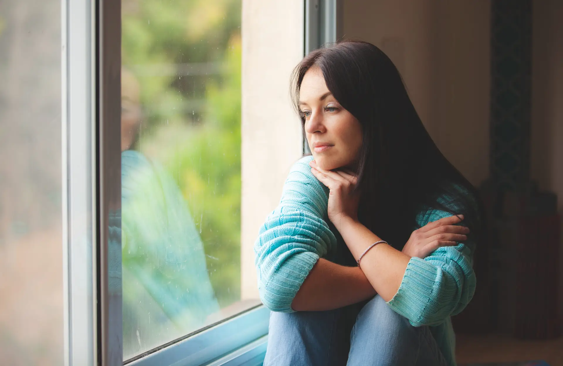 woman sitting on the window sill