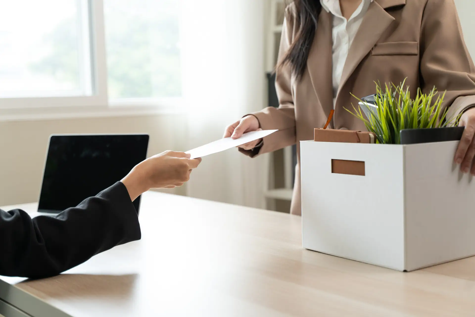 Unemployment ,jobless crisis, worker layoff concept, Close-up of young businessman pack stuff off the desk and holding boxes of self stuff when quitting the job after send resign letter from company