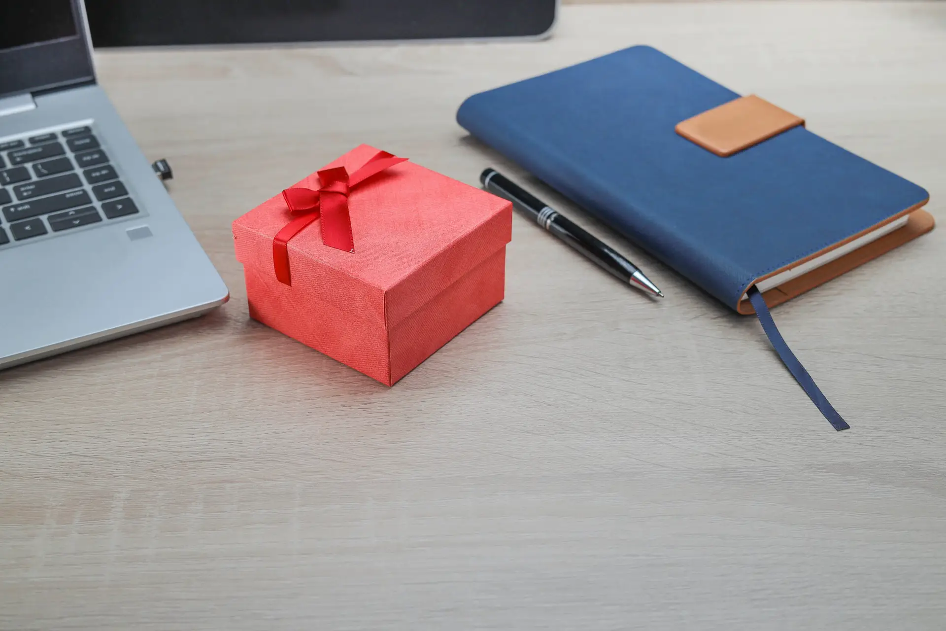 Corruption and no gift policy concept. A red gift box on the wooden office  table