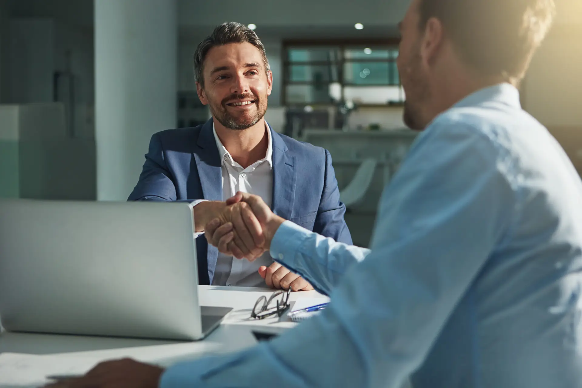 Business people, handshake and interview success or recruitment, employment and hiring in office. Corporate, men and executive shaking hands with new employee or collaboration on deal or partnership