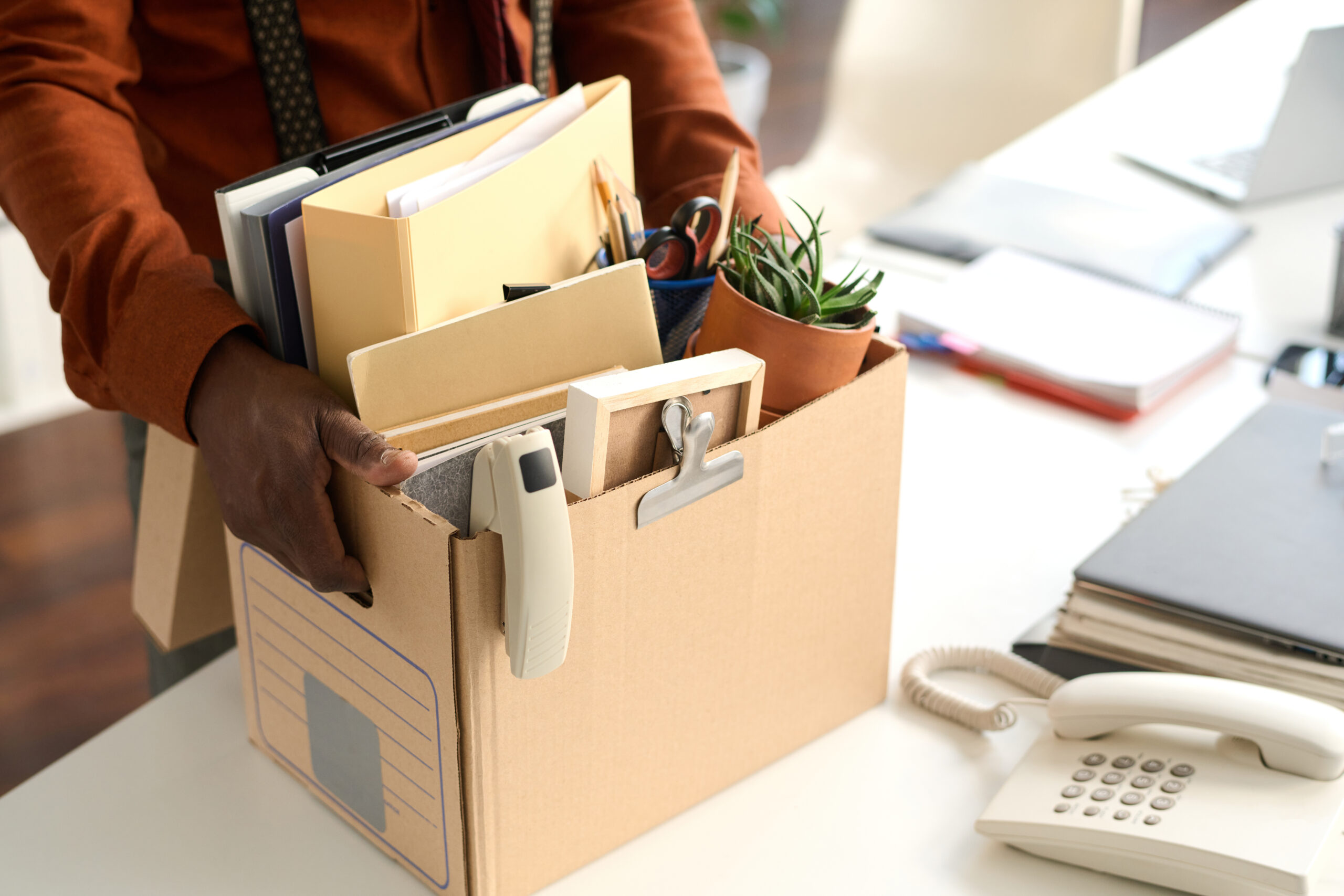 Black Man Holding Box in Office Closeup
