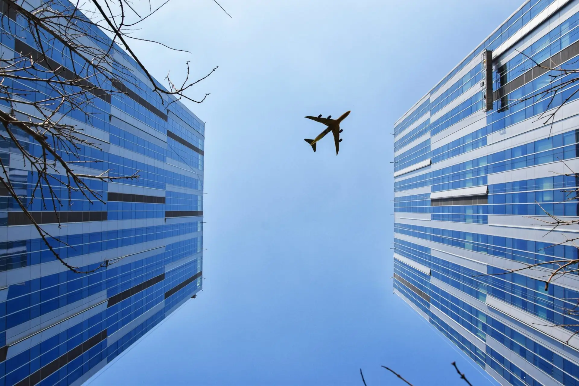 airplane-near-blue-and-grey-building-747079-scaled-1