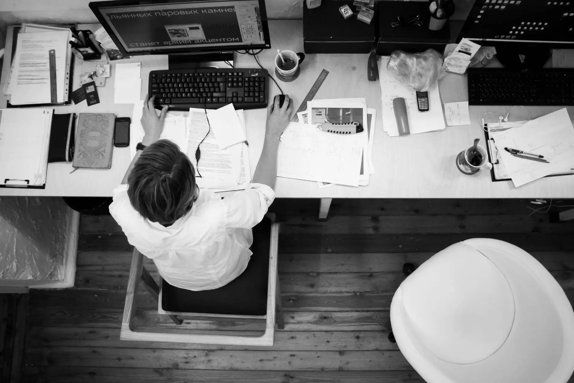black-and-gray-photo-of-person-in-front-of-computer-monitor-140945-scaled-1