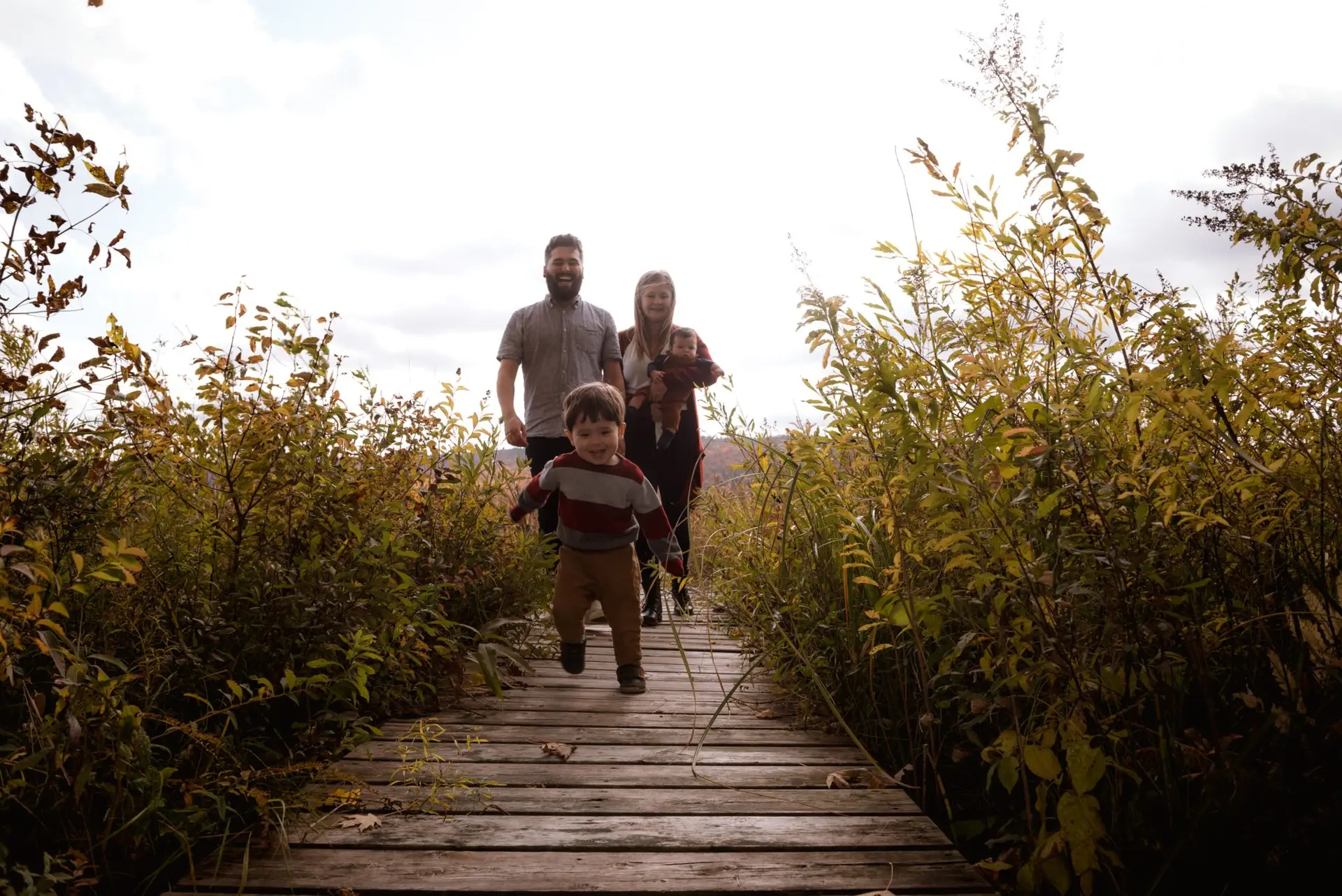boy-running-on-bridge-near-his-parents-3204077