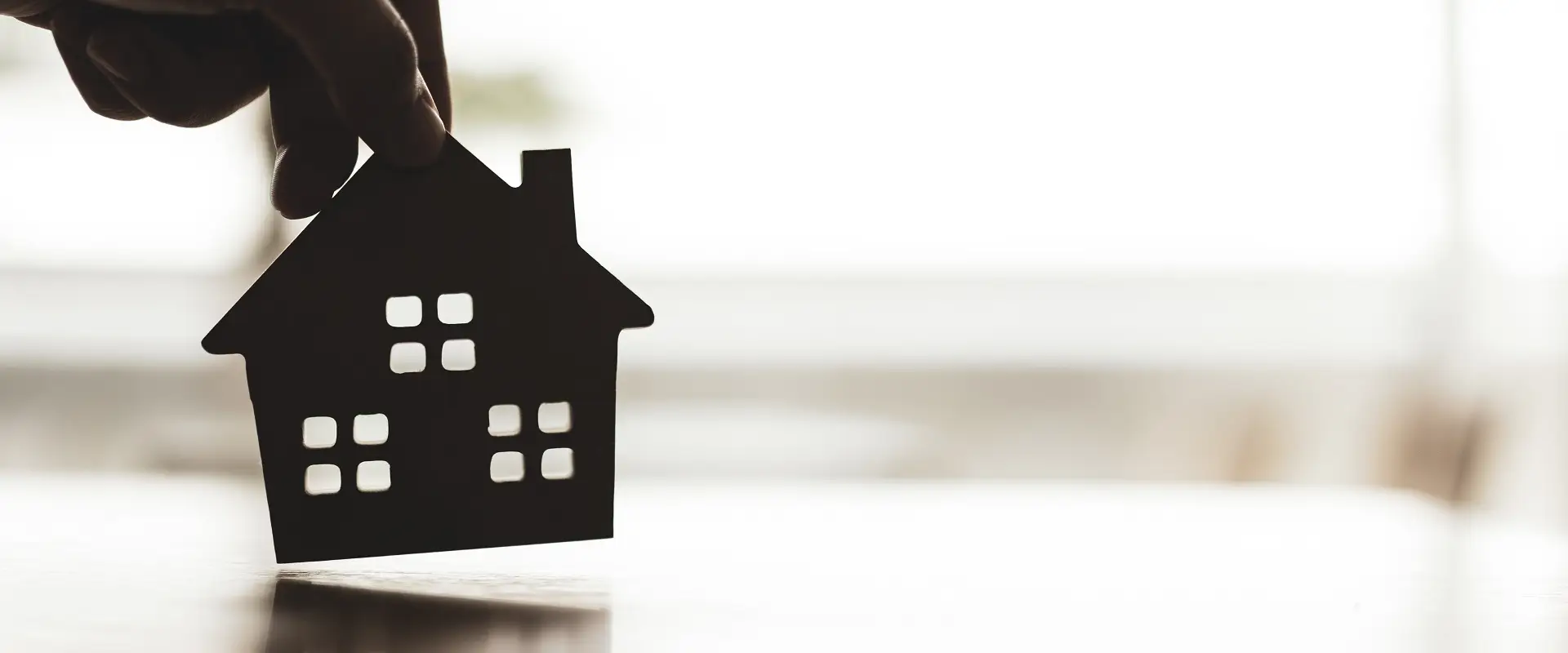 hand-holding-a-house-model-sepia