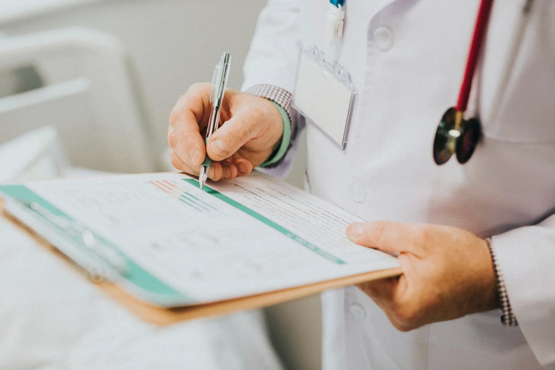 physician-noting-down-symptoms-patient
