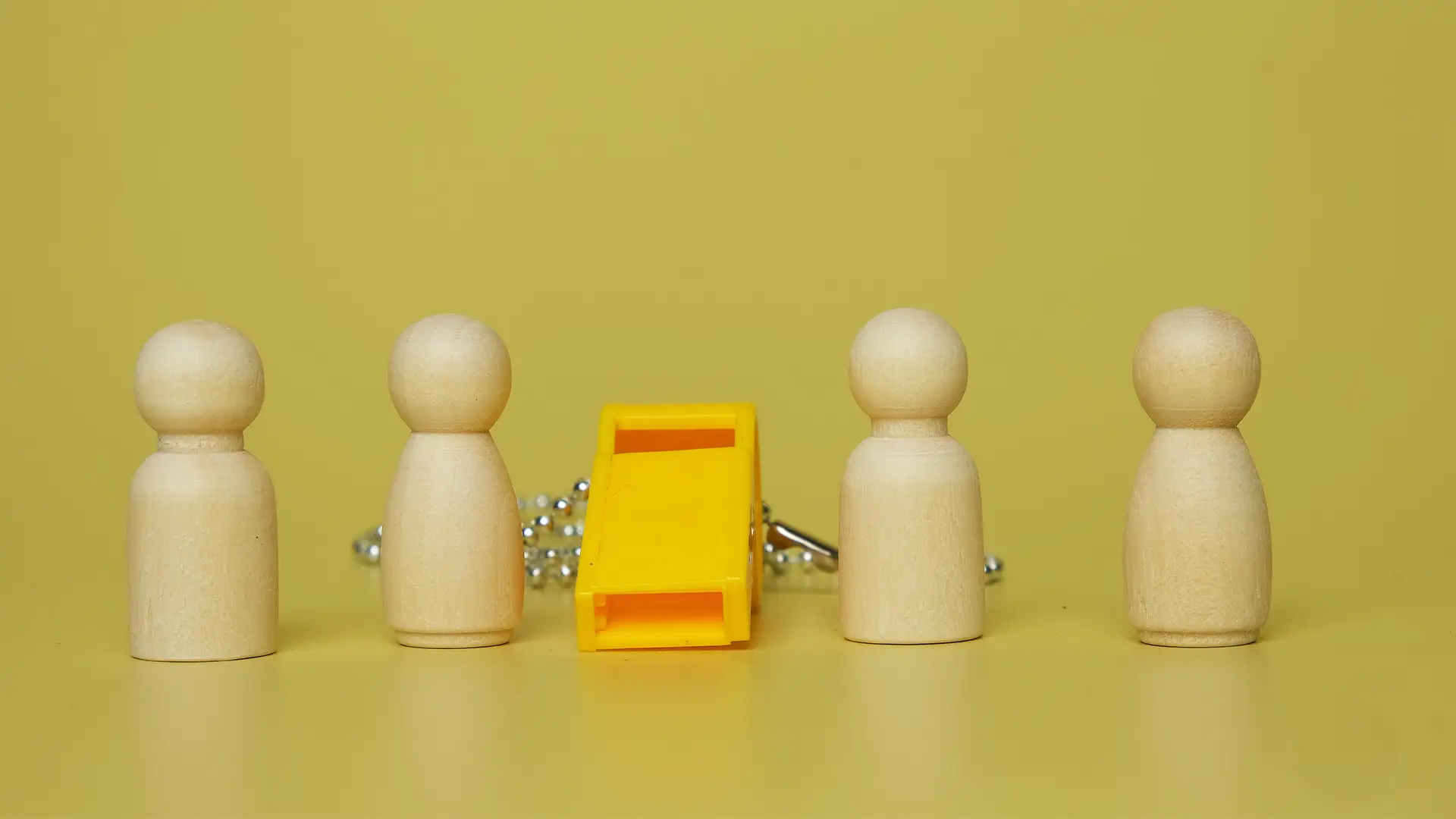 whislteblower-concept-standing-row-of-pegs-and-whistle